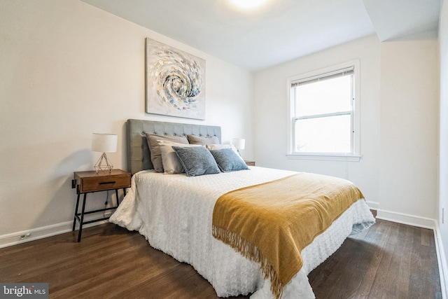 bedroom with dark wood-style floors and baseboards