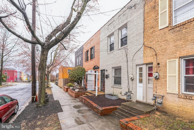 exterior space featuring entry steps and brick siding