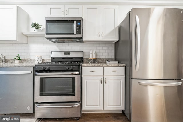 kitchen with stainless steel appliances, white cabinetry, dark wood-style floors, open shelves, and tasteful backsplash