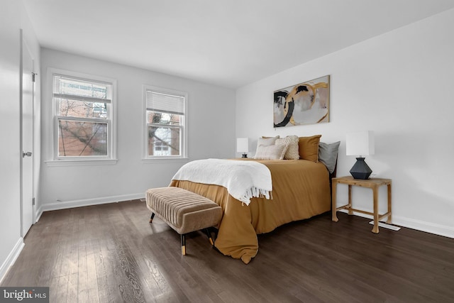 bedroom featuring wood-type flooring and baseboards