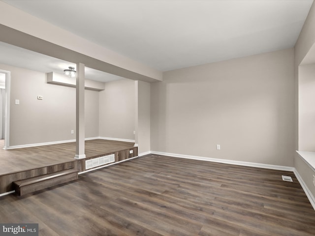 interior space with visible vents, baseboards, and wood finished floors