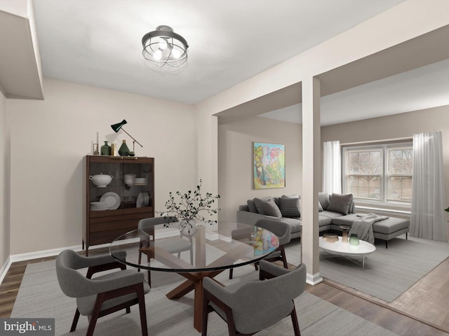 dining area with wood finished floors and baseboards