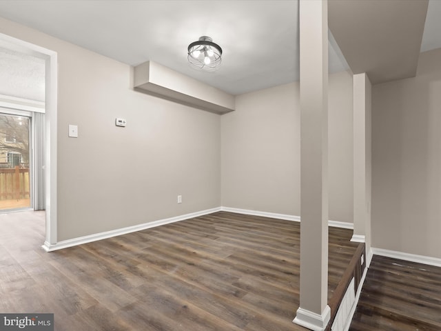 below grade area featuring baseboards and wood finished floors