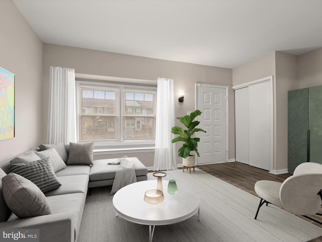 living area featuring wood finished floors and baseboards