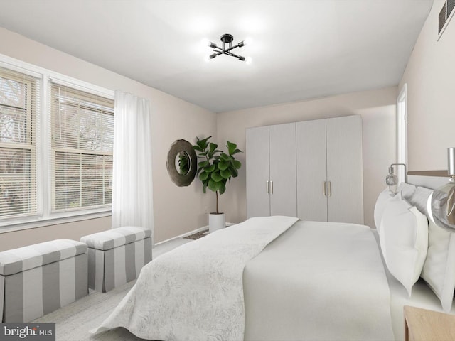 bedroom featuring visible vents and a closet