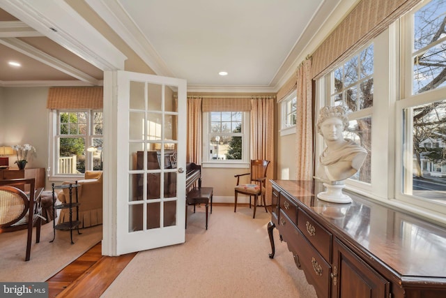 interior space with plenty of natural light, baseboards, and ornamental molding