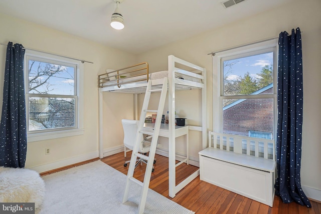 bedroom featuring wood finished floors and baseboards