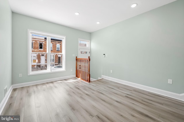 unfurnished room featuring light wood-style flooring, visible vents, baseboards, and recessed lighting