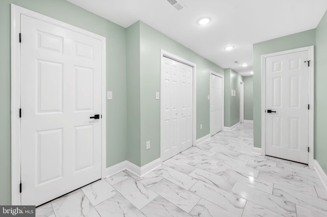 hallway featuring recessed lighting, marble finish floor, visible vents, and baseboards