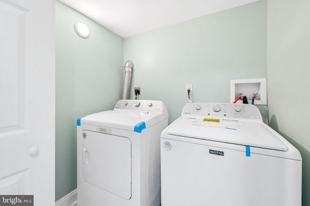 clothes washing area featuring washing machine and dryer and laundry area