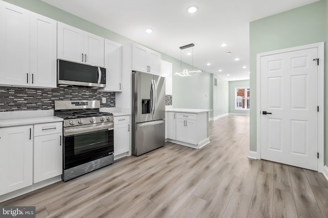 kitchen with light countertops, appliances with stainless steel finishes, light wood-style floors, and tasteful backsplash