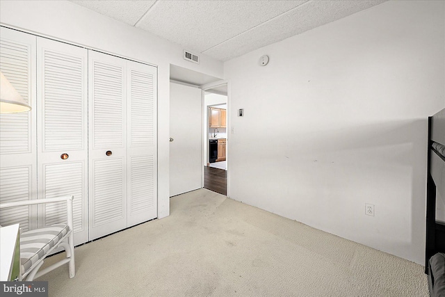 10000 Coastal Hwy Unit 1208, Ocean City, MD 21842 - unfurnished bedroom with a closet, visible vents, light colored carpet, and a textured ceiling