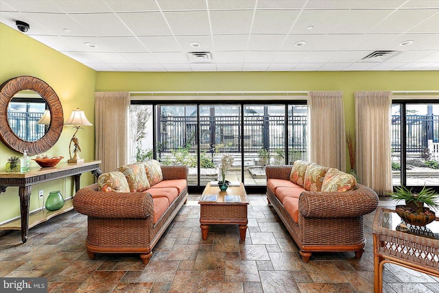 10000 Coastal Hwy Unit 1208, Ocean City, MD 21842 - living room with stone tile floors, visible vents, and a healthy amount of sunlight