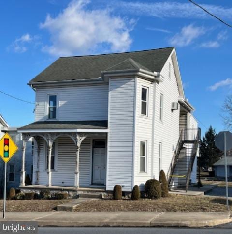 view of front of home with stairs and a porch