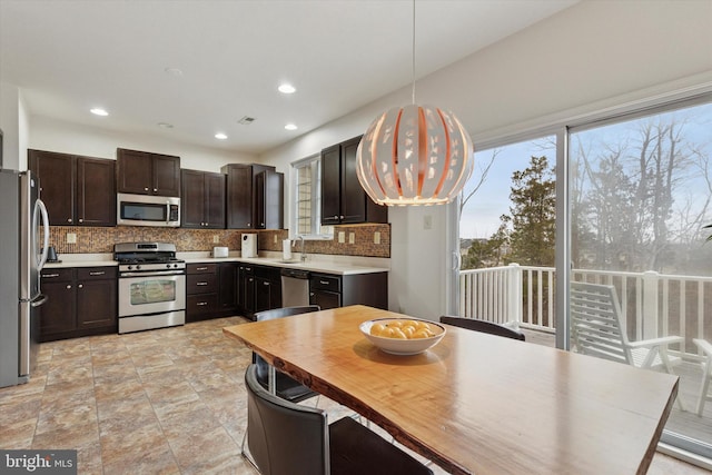 kitchen with a sink, a wealth of natural light, stainless steel appliances, and backsplash