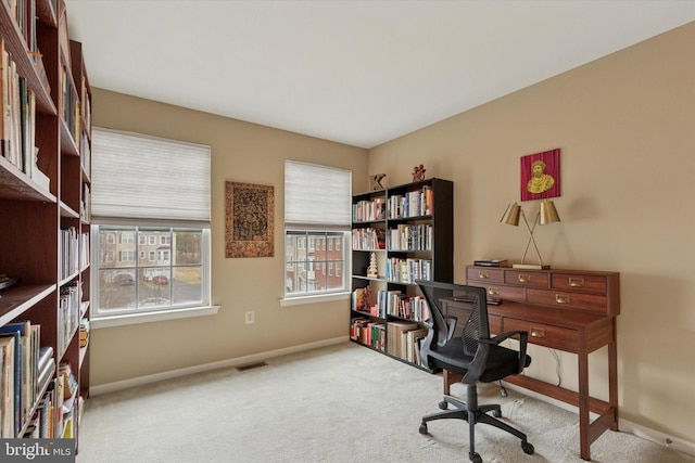 carpeted office with visible vents and baseboards