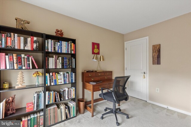 carpeted office featuring baseboards