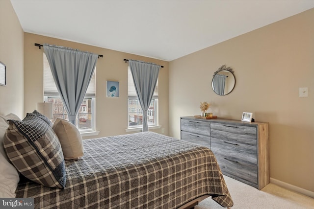 carpeted bedroom featuring baseboards