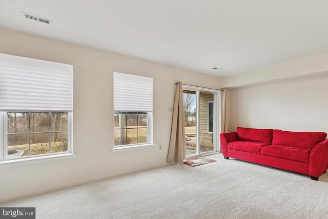 carpeted living room featuring visible vents