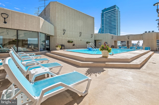 community pool with a patio area