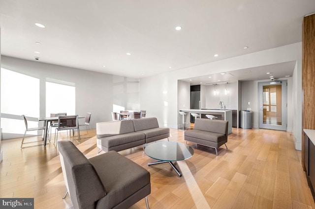 living room with light wood-style floors and recessed lighting