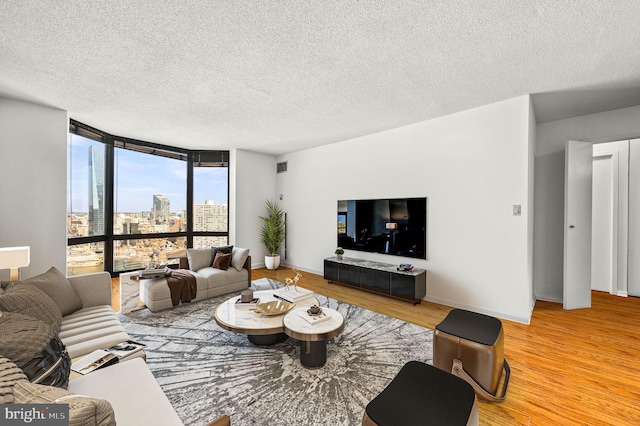 living area featuring expansive windows, wood finished floors, and baseboards