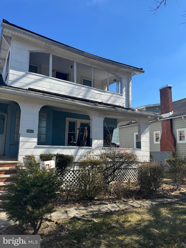 view of front of property with a porch and a balcony