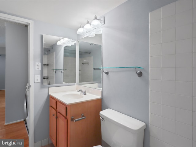 bathroom with wood finished floors, vanity, and toilet