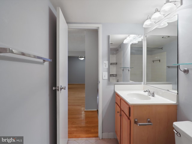 full bathroom featuring baseboards, vanity, toilet, and tile patterned floors