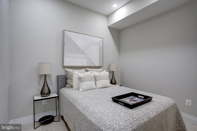 bedroom featuring light wood-type flooring and baseboards