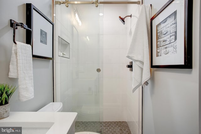 bathroom featuring a stall shower, vanity, and toilet