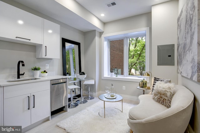 interior space with electric panel, baseboards, visible vents, light wood-style flooring, and recessed lighting