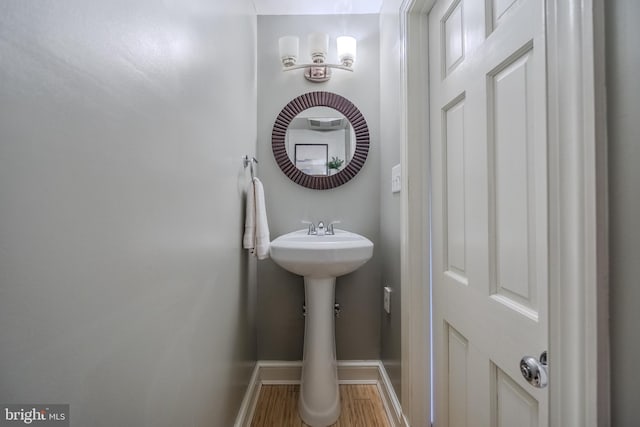 bathroom with baseboards and wood finished floors