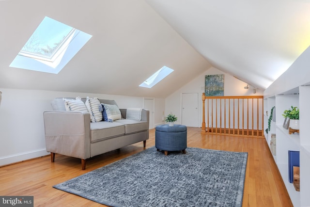 living area with lofted ceiling and wood finished floors