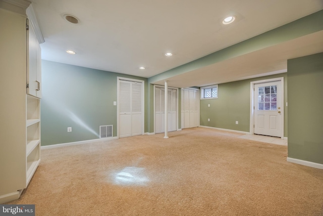 basement with recessed lighting, visible vents, baseboards, and light colored carpet