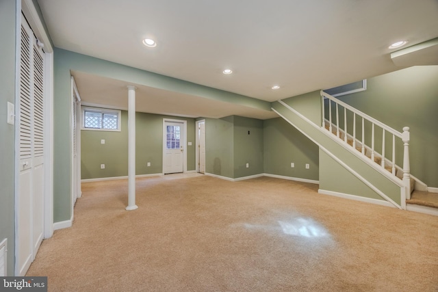 below grade area with light colored carpet, stairway, recessed lighting, and baseboards