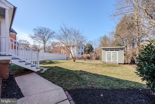 view of yard with a storage unit, an outdoor structure, and fence