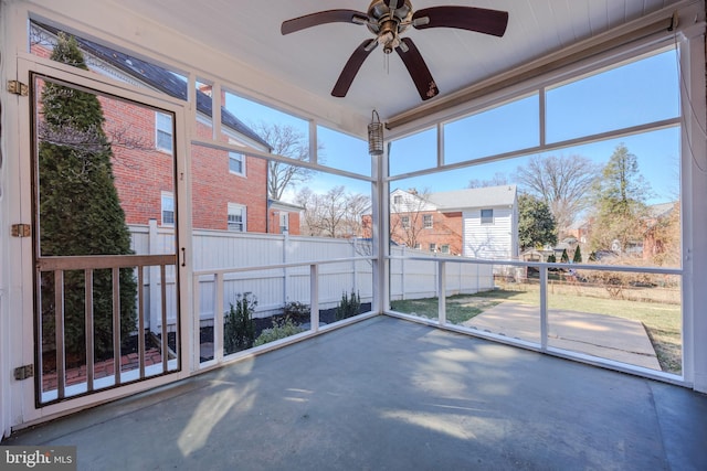 unfurnished sunroom with a wealth of natural light and ceiling fan