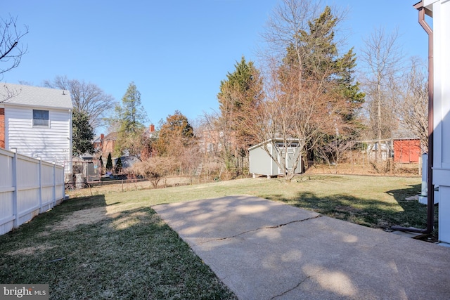 view of yard with a patio area, fence private yard, a storage shed, and an outdoor structure