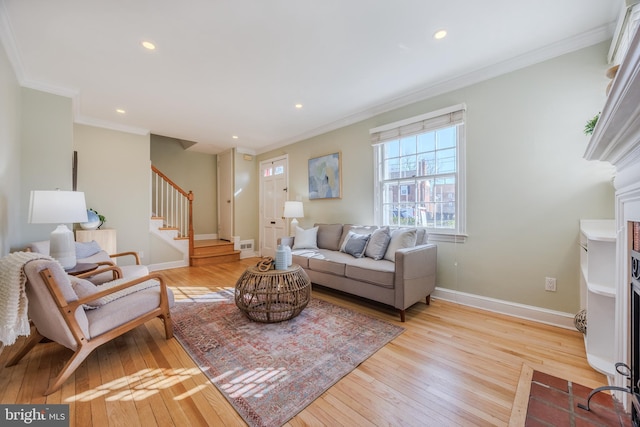 living room with light wood finished floors, baseboards, stairs, ornamental molding, and recessed lighting