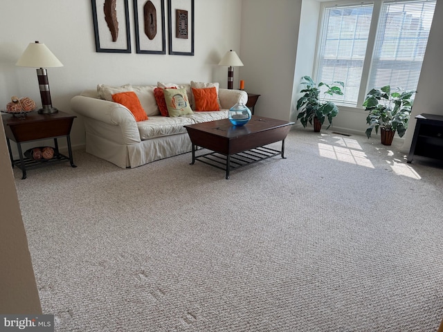 carpeted living area with baseboards