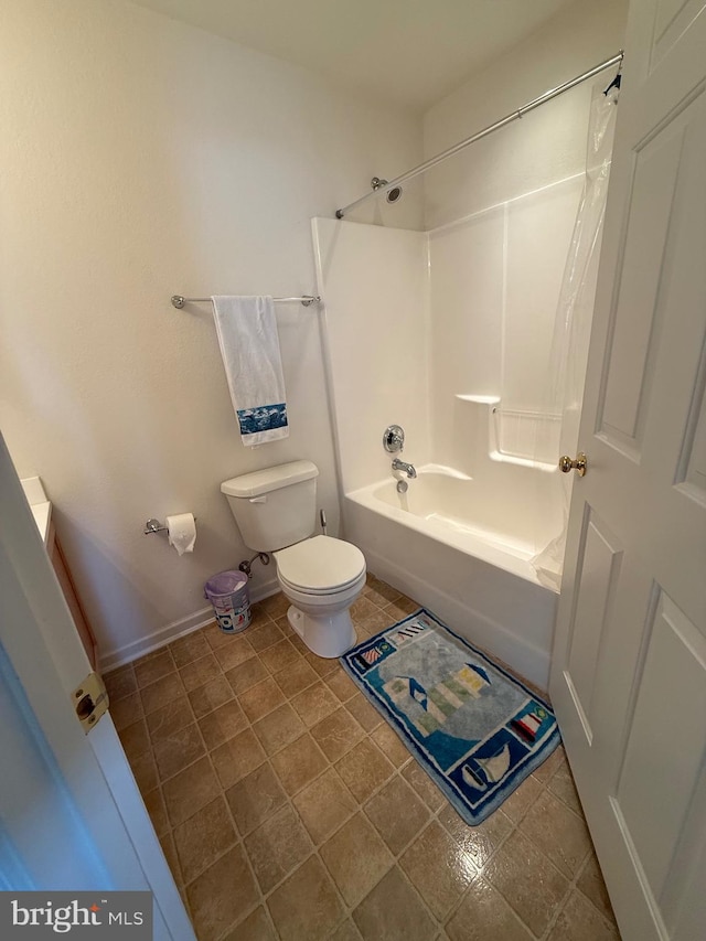 full bath featuring toilet, washtub / shower combination, and baseboards