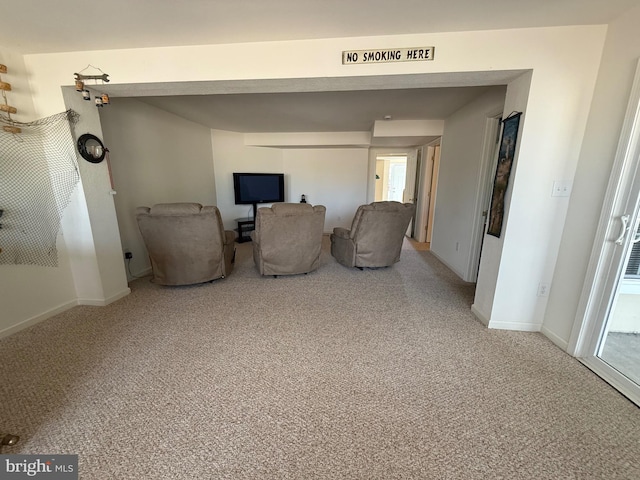 unfurnished room with baseboards and light colored carpet