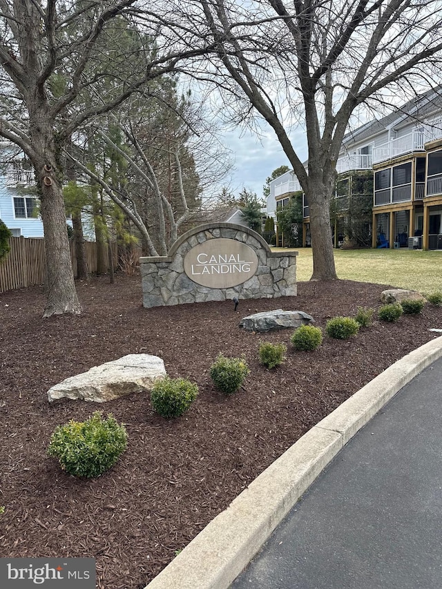 community sign with a yard and fence