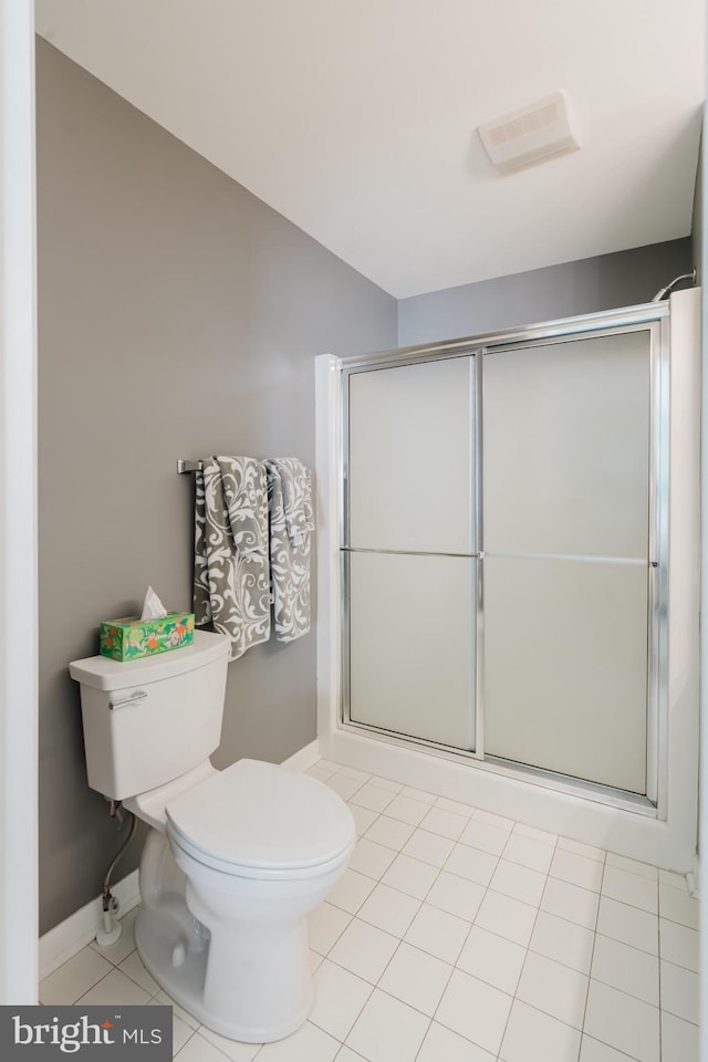 bathroom featuring visible vents, baseboards, a stall shower, tile patterned floors, and toilet