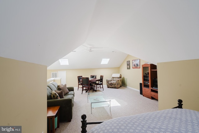 carpeted bedroom with baseboards, lofted ceiling with skylight, and visible vents