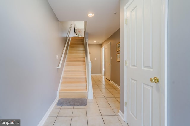 staircase with tile patterned floors, recessed lighting, and baseboards