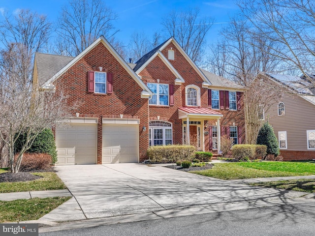 view of front of home with a garage, concrete driveway, and brick siding