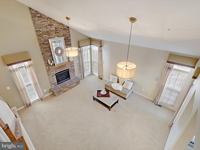 carpeted living area with high vaulted ceiling, a healthy amount of sunlight, a fireplace, and baseboards