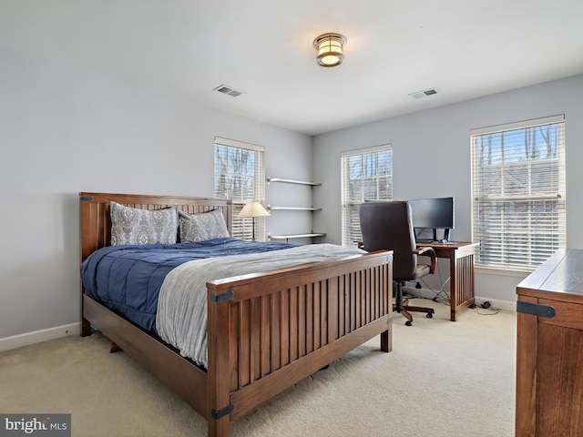 bedroom with baseboards, visible vents, and light colored carpet